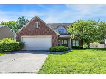 Charming two-story home featuring brick accents, attached garage, and well-manicured lawn at 7587 Winding Way, Fishers, IN 46038