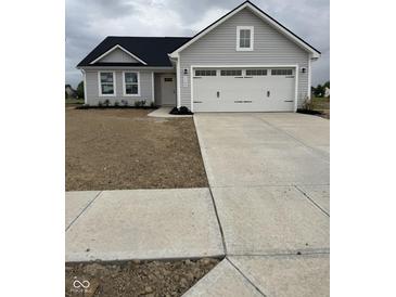 Charming single-story home with a large garage, gray siding, and a neatly paved driveway at 1193 Brightwood Cir, Greenfield, IN 46140