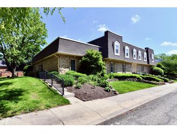 Inviting brick townhouse with a well-manicured lawn and charming curb appeal at 1310 Kings Cove Ct, Indianapolis, IN 46260