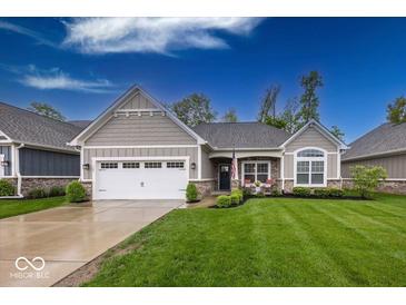 Charming home with a well-manicured lawn, two-car garage, and inviting front porch area at 1701 Summerwood Blvd, Greenfield, IN 46140