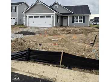 Charming gray single-story home with a two-car garage and undergoing landscaping at 1730 Juniper Ln, Greenfield, IN 46140