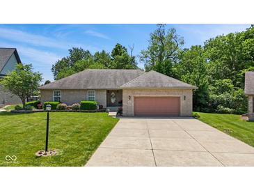 Charming ranch home featuring a well-maintained lawn, landscaping, and a two-car garage at 205 Canaan Ct, Mooresville, IN 46158