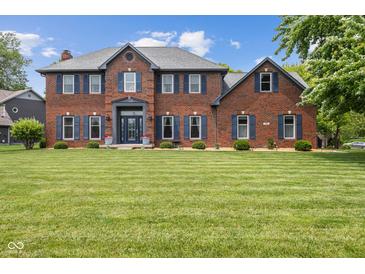 Charming two-story brick home featuring blue shutters and a well-manicured lawn at 248 Runyon Ct, Greenwood, IN 46142