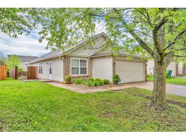 Charming single-story home featuring a well-manicured lawn, attached garage, and neutral siding at 2740 Braxton Dr, Indianapolis, IN 46229