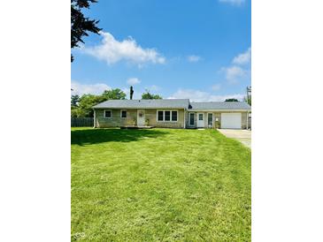 Charming single-story home with stone facade, well-manicured lawn, and inviting front entrance at 3414 Rost Dr, Columbus, IN 47203