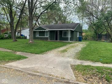 Charming single-story home featuring a cozy porch and a well-maintained lawn at 3742 N Wittfield St, Indianapolis, IN 46235