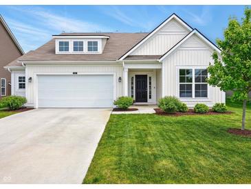 Charming home featuring a well-maintained lawn, attached garage, and inviting front entrance at 4367 Homestead Dr, Whitestown, IN 46075