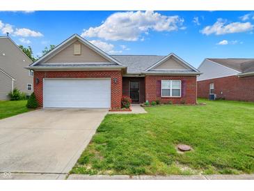 Charming single-story brick home with a well-maintained lawn and a two-car garage at 5305 Adrian Orchard Dr, Indianapolis, IN 46217