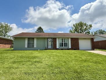 Charming one-story home featuring a lush green lawn, attached garage, and a welcoming entrance at 539 Willow Dr, Danville, IN 46122