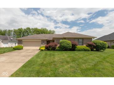 Charming brick ranch-style home featuring a well-manicured lawn and mature landscaping at 897 N Scott Dr, Greenwood, IN 46142