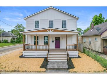 Charming two-story home with a welcoming front porch and freshly landscaped yard at 1825 E Maryland St, Indianapolis, IN 46201