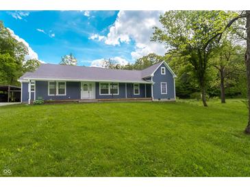 Charming single-story home boasts a well-manicured lawn and inviting front porch, perfect for enjoying the outdoors at 2935 N Grizzly Ln, Martinsville, IN 46151