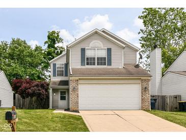 Charming two-story home featuring vinyl siding, brick accents, and an attached two-car garage at 3839 Churchman Woods Blvd, Indianapolis, IN 46203