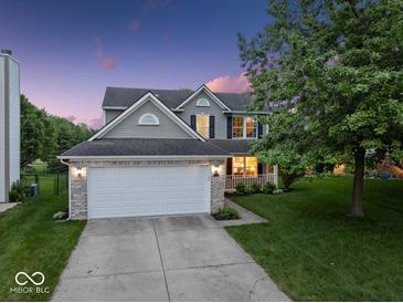 Charming home with a two-car garage, well-manicured lawn, and a lovely front porch at 5041 Millwright Ct, Indianapolis, IN 46254