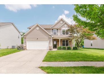 Charming two-story home featuring a two-car garage, well-manicured lawn, and inviting front porch at 5913 Monticello Square Ln, Indianapolis, IN 46234