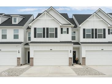 New construction townhouse with attached garage, black shutters and gray landscaping at 7258 Selah Ln, Noblesville, IN 46062