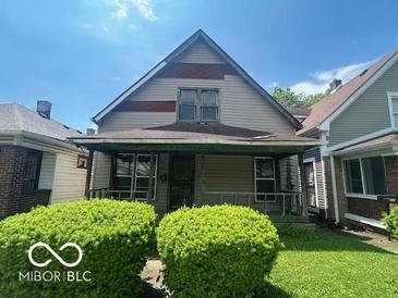 Modest two-story home featuring a covered front porch and neutral siding at 811 W 25Th St, Indianapolis, IN 46208