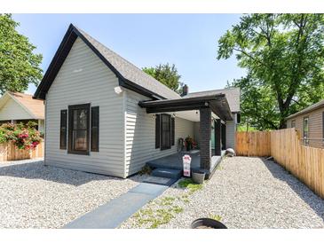 Charming one-story home with gravel landscaping and a covered front porch, providing a welcoming curb appeal at 853 S Belleview Pl, Indianapolis, IN 46221