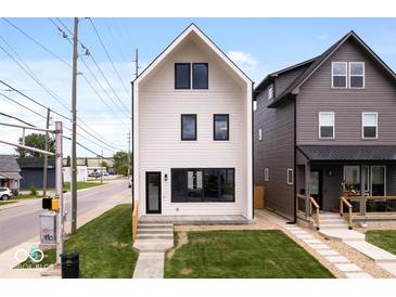 Modern two-story home with white siding, black trim, and well-manicured lawn at 1100 English Ave, Indianapolis, IN 46203