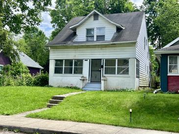 Two-story home featuring a well-maintained lawn, creating a welcoming curb appeal at 1137 W 34Th St, Indianapolis, IN 46208