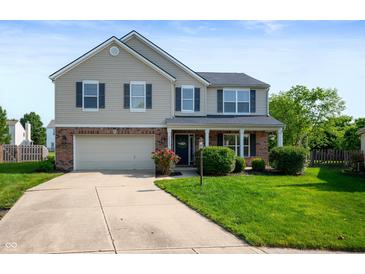 Attractive two-story home featuring a well-kept lawn, attached garage, and welcoming entrance at 12331 Chiseled Stone Dr, Fishers, IN 46037