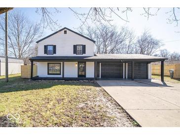 Charming two-story home with a spacious driveway and an attached two car garage at 1808 Raible Ave, Anderson, IN 46011