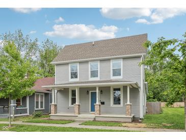 Charming two-story home with a covered porch, vinyl siding, and a well-maintained front yard at 2229 N Arsenal Ave, Indianapolis, IN 46218