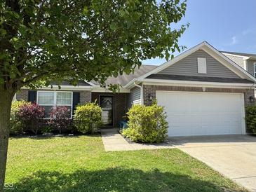 Charming single-Gathering home features a well-manicured lawn and attached two car garage at 2911 W Hawanian Ln, Monrovia, IN 46157
