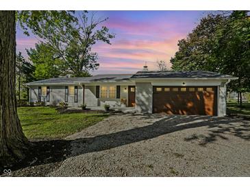 Charming brick ranch-style home with a two-car garage and a well-manicured front yard at 2956 N 700 E, Franklin, IN 46131