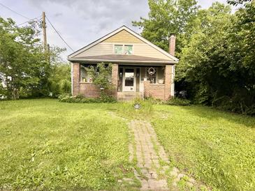 Charming home features a brick exterior, inviting front porch and a brick pathway leading to the entrance at 3745 Winthrop Ave, Indianapolis, IN 46205