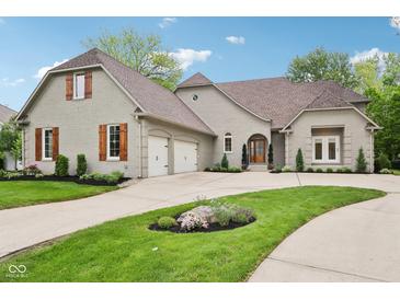 Beautiful exterior view of home showcasing the brick facade, wooden shutters, and well-manicured lawn at 5786 E Fall Creek Pkwy N Dr, Indianapolis, IN 46226