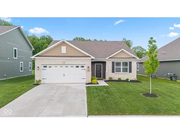 Charming single-story home featuring a brick facade, attached garage, and well-maintained lawn at 6609 Dunkirk Dr, McCordsville, IN 46055