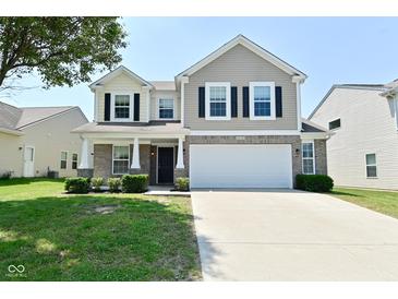 Traditional two-story home with a large two car garage and beautiful front lawn at 8354 Fieldfare Way, Indianapolis, IN 46237