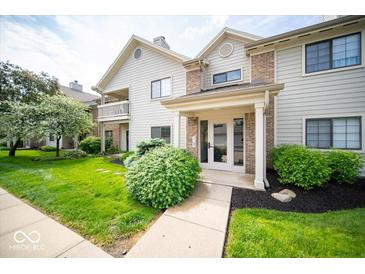 Inviting home exterior featuring a well-manicured lawn and charming architectural details at 931 Wickham Ct # 101, Carmel, IN 46032