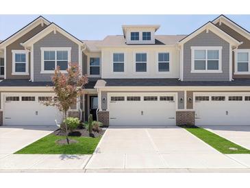 Attractive townhome with a two-car garage and well-maintained landscaping at 9583 Beckett St, Avon, IN 46123