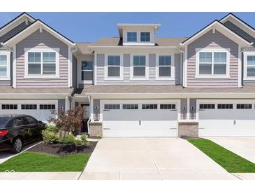 Charming townhome with a two-car garage, well-maintained landscaping, and inviting curb appeal at 9652 Beckett St, Avon, IN 46123