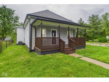 Charming home featuring a welcoming front porch, updated siding, and a well-maintained lawn at 1520 E Kirk St, Muncie, IN 47303