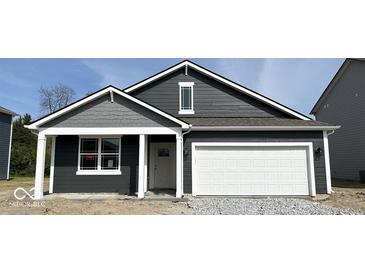 Charming single-story home featuring a white garage door, dark siding, and eye-catching architectural details at 5203 Cartland Dr, Indianapolis, IN 46239