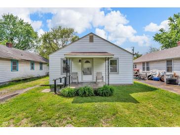 Charming single-story home featuring a cozy porch, well-kept lawn, and classic design at 1124 S Lockburn St, Indianapolis, IN 46241