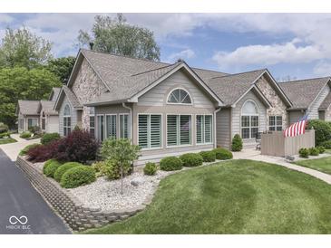 Charming home featuring a stone facade, manicured lawn, and well-kept landscaping at 1130 Deerbrook Trl, Greenwood, IN 46142