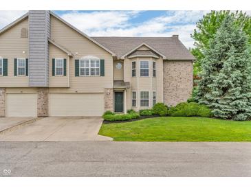 Inviting home featuring an attached garage, neutral siding, green lawn, and tasteful landscaping at 1139 Fernwood Way, Plainfield, IN 46168