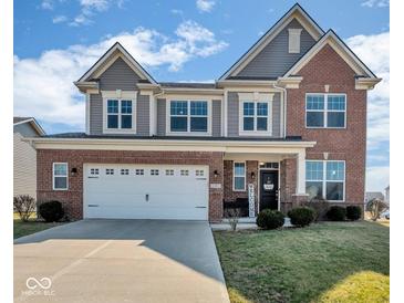 Charming two-story home with brick and gray siding, featuring a welcoming front entrance and a two-car garage at 1381 Avocet Dr, Greenwood, IN 46143