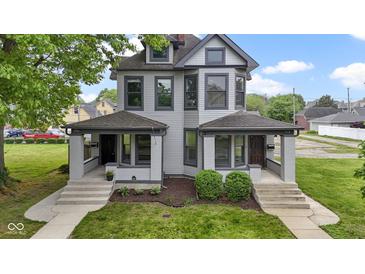 Charming two-story duplex featuring well-maintained landscaping and a classic facade with inviting front porches at 1526 Carrollton Ave, Indianapolis, IN 46202