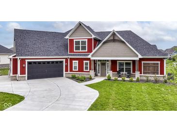 Inviting two-story home showcasing a well-manicured lawn and dark garage doors at 1595 N Blue Rd, Greenfield, IN 46140