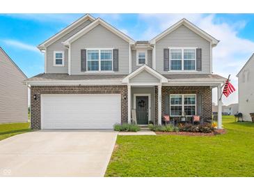 Charming two-story home with a brick and siding exterior, well-manicured lawn, and an attached two-car garage at 1893 Glenmoor Ct, Columbus, IN 47201