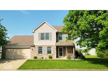 Charming two-story home with a well-manicured lawn, attached garage, and inviting front porch at 2 E Quail Wood Ln, Westfield, IN 46074