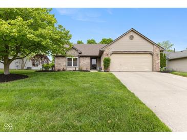 Charming single-story home with a well-manicured lawn and attached two-car garage at 3630 Foxtail Dr, Indianapolis, IN 46235