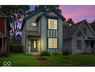 Charming two-story home with blue trim and a well-manicured lawn, perfect for a Gathering at 3658 Graceland Ave, Indianapolis, IN 46208