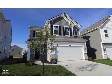 Two story home features a two car garage, grey siding, black shutters, and manicured lawn at 6223 Medina Spirit Dr, Indianapolis, IN 46237
