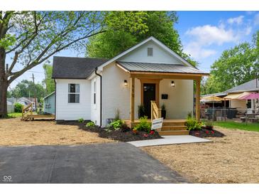White brick home with new landscaping and a driveway leading to the entrance at 650 Overstreet St, Franklin, IN 46131